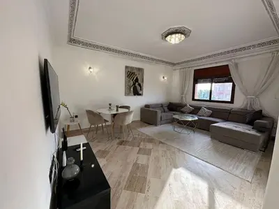 a living room with a couch and a table at Luxury, Cosy Apartement (Wifi, Balcony, Parking) in Marrakech