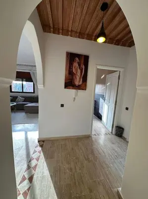 an empty living room with a painting on the wall at Luxury, Cosy Apartement (Wifi, Balcony, Parking) in Marrakech