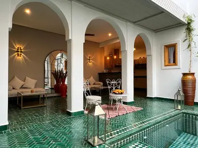 a villa with a swimming pool and a living room at Riad Darchica in Marrakech