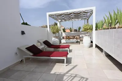 a patio with two chairs and a gazebo at Riad avec piscine - Wifi- petit déjeuner - Bon Emplacement in Marrakech