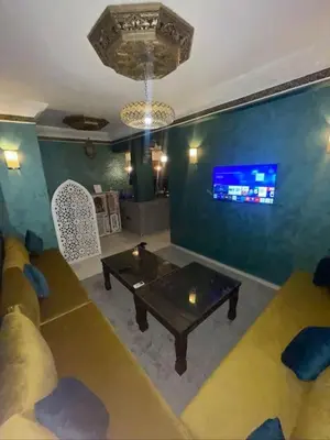 a living room with a couch and a table at Appartement style Riad, 2 chambres, ambiance cosy in Marrakech
