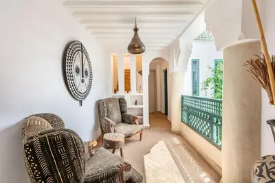 a living room with two chairs and a table at Charming riad in the medina of Marrakech with 4 nice rooms in Marrakech