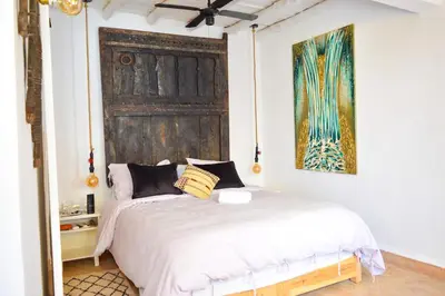 a bedroom with a bed with a large wooden door at Charming riad in the medina of Marrakech with 4 nice rooms in Marrakech