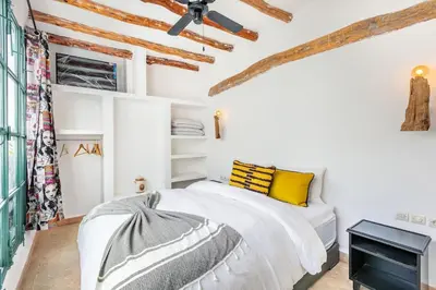 a white bedroom with a bed and a ceiling at Charming riad in the medina of Marrakech with 4 nice rooms in Marrakech