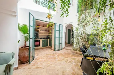 a room with plants and a glass door at Charming riad in the medina of Marrakech with 4 nice rooms in Marrakech
