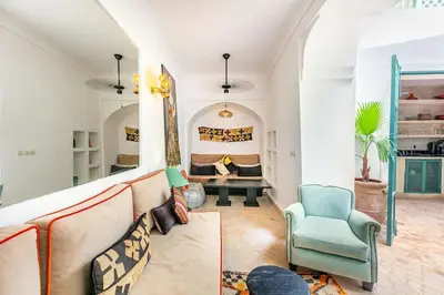 a living room with a couch and a chair at Charming riad in the medina of Marrakech with 4 nice rooms in Marrakech