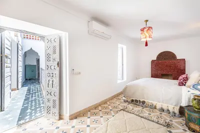 a bedroom with a bed and a hallway with an archway at Riad Itri (إتري) Exclusif - Marrocan Breakfast in Marrakech