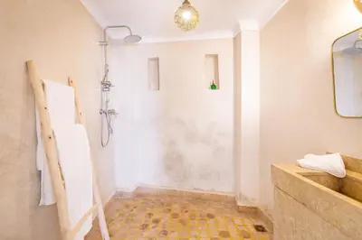 a bathroom with a shower and a sink at Riad Itri (إتري) Exclusif - Marrocan Breakfast in Marrakech