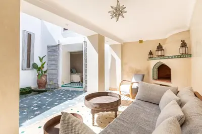 a living room with a couch and a fireplace at Riad Itri (إتري) Exclusif - Marrocan Breakfast in Marrakech