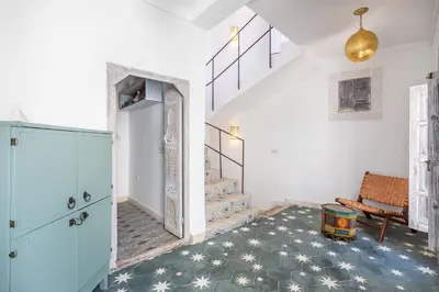 a room with a staircase and a blue cabinet at Riad Itri (إتري) Exclusif - Marrocan Breakfast in Marrakech