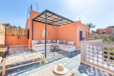 an outdoor patio with a couch and a table at Riad Itri (إتري) Exclusif - Marrocan Breakfast in Marrakech