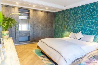 a bedroom with a large bed and a green wall at Villa Boutique Amani in Marrakech
