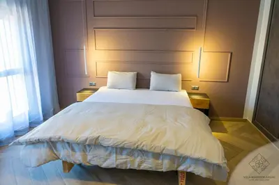 a bedroom with a large white bed with two pillows at Villa Boutique Amani in Marrakech