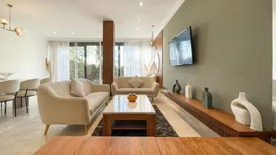 a living room with a couch and a table at Villa Atlas piscine chauffée à Marrakech in Marrakech