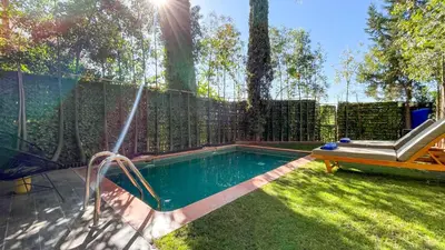 a swimming pool in a backyard with a fence at Villa Atlas piscine chauffée à Marrakech in Marrakech