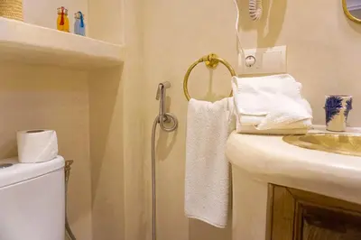 a bathroom with a sink and a shower with towels at Flowers riad in Marrakech