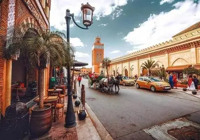 a street in a city with cars and a building at DAR IJLAL in Marrakech