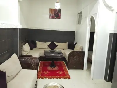 a living room with a couch and a table at DAR IJLAL in Marrakech