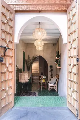 an archway leading into a room with a table and chairs at Riad BE Marrakech in Marrakech