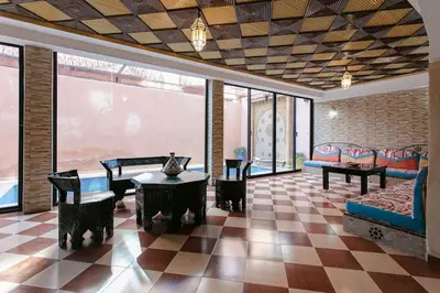 a living room with a couch and a table at Riad Tranquility - A Timeless Marrakech Haven in Marrakech