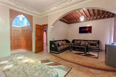 a living room with a couch and a table at Riad Tranquility - A Timeless Marrakech Haven in Marrakech