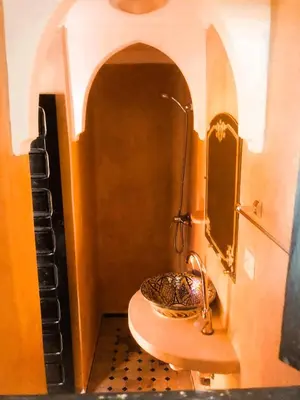 a bathroom with a sink and a toilet in a room at Quarya Assiyahia - Riad CAMILIA- Maison entière avec piscine in Marrakech