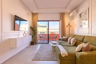 a living room with a couch and a television at New! Appartement Diana calme ,Terrasse in Marrakech