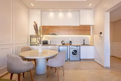 a kitchen with a table and chairs in a kitchen at New! Appartement Diana calme ,Terrasse in Marrakech