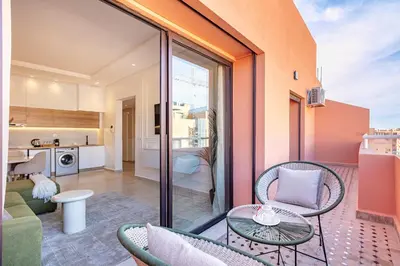 a balcony with a table and chairs and a kitchen at New! Appartement Diana calme ,Terrasse in Marrakech
