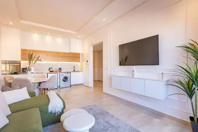 a living room with a couch and a tv on a wall at New! Appartement Diana calme ,Terrasse in Marrakech