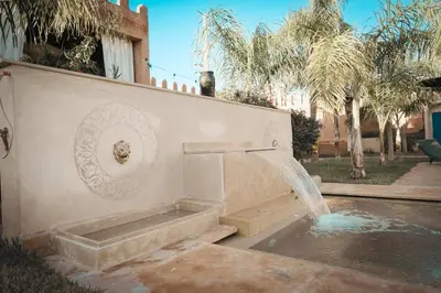 a fountain on a wall in a yard at Riad Safran Ralya in Marrakech