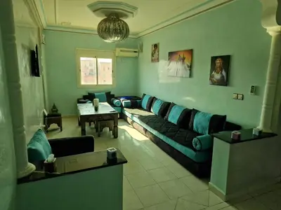 a living room with a couch and a table at appartement sympathique à Marrakech in Marrakech