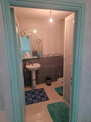 a bathroom with a sink and a mirror at appartement sympathique à Marrakech in Marrakech