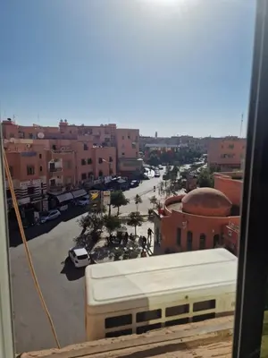a view of a city with a street and buildings at appartement sympathique à Marrakech in Marrakech