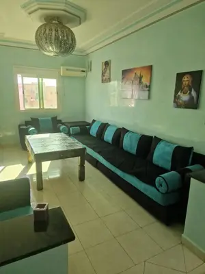 a living room with a couch and a table at appartement sympathique à Marrakech in Marrakech