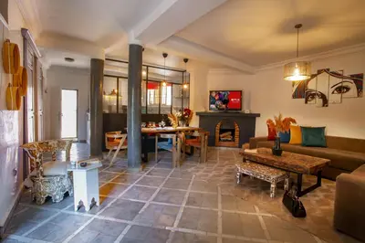 a living room with a couch and a table at Villa Cosy Piscine Proche centre-ville 4 suites in Marrakech