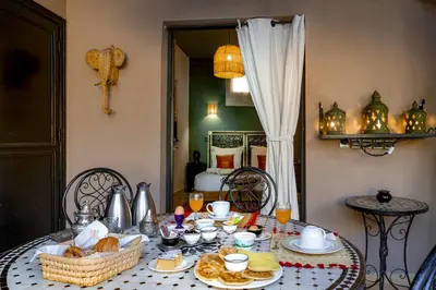 a table with food and drinks on top of it at Villa Cosy Piscine Proche centre-ville 4 suites in Marrakech
