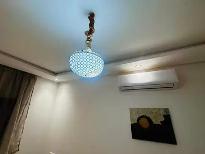a light hanging from the ceiling of a room at Riad hotel Cecil in Marrakech