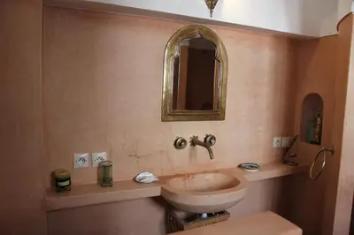 a bathroom with a sink and a mirror at Riad Jnan El Cadi in Marrakech