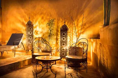 a patio with chairs and a table and lights at Riad Jnan El Cadi in Marrakech