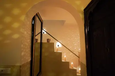 an archway with candles on the stairs in a room at Riad Coco Marrakech in Marrakech