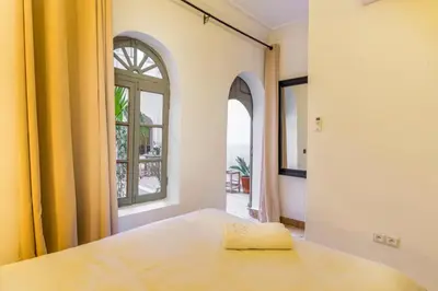 a bedroom with a bed and a window at Riad Coco Marrakech in Marrakech