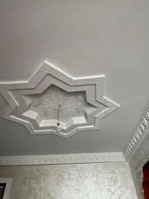 a coffered ceiling in a room with a white ceiling at Stylish Moroccan Apartment Near Marrakech Airport in Marrakech