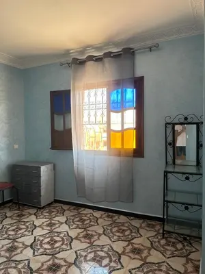a room with a window and a dresser in it at Stylish Moroccan Apartment Near Marrakech Airport in Marrakech