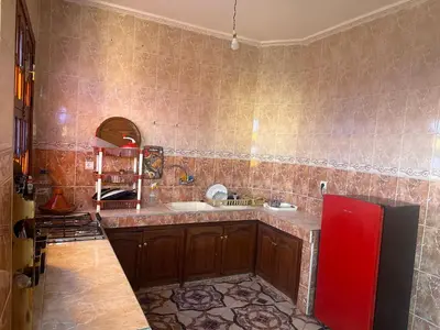 a kitchen with a counter and a sink in it at Stylish Moroccan Apartment Near Marrakech Airport in Marrakech