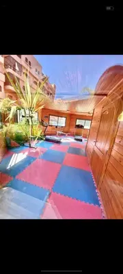 a room with a colorful floor in a building at Appartement Ensoleillé vue Piscine in Marrakech