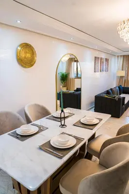 a dining room with a large table and chairs at TheCasaEdition - Gueliz Apartments in Marrakech