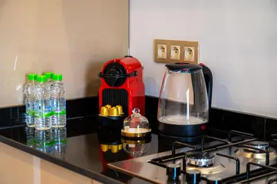 a kitchen counter with a coffee maker on a stove at TheCasaEdition - Gueliz Apartments in Marrakech