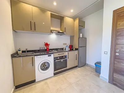 a kitchen with a washing machine and a washer at TheCasaEdition - Gueliz Apartments in Marrakech