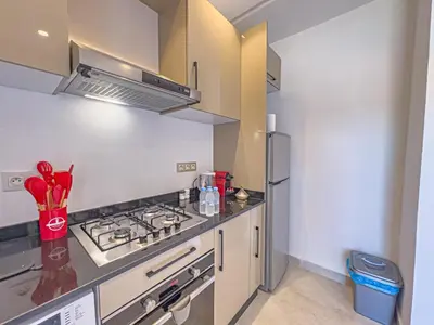 a kitchen with a stove and a refrigerator at TheCasaEdition - Gueliz Apartments in Marrakech